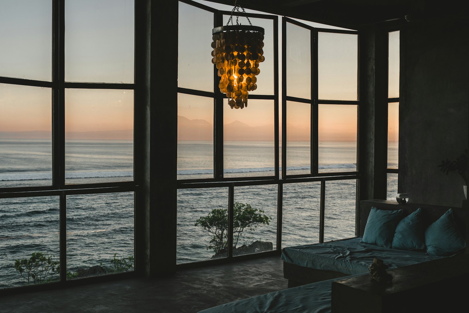 An elegant, minimal room with an ocean view at golden hour